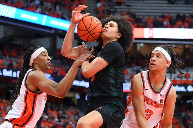 Jan 20, 2024; Syracuse, New York, USA; Syracuse Orange forward Maliq Brown (1) reaches for the ball controlled by Miami (Fl) Hurricanes guard Kyshawn George (7) as Syracuse Orange forward Benny Williams (13) lopoks on during the first half at the JMA Wireless Dome. Miami (Fl) Hurricanes guard Kyshawn George (7) was called for an offensive foul on the play. Mandatory Credit: Rich Barnes-USA TODAY Sports