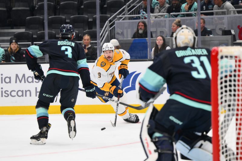 Nov 2, 2023; Seattle, Washington, USA; Nashville Predators left wing Filip Forsberg (9) plays the puck while defended by Seattle Kraken defenseman Will Borgen (3) during the second period at Climate Pledge Arena. Mandatory Credit: Steven Bisig-USA TODAY Sports