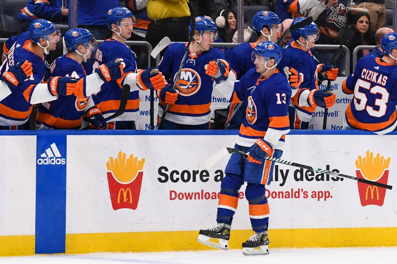 Dec 13, 2023; Elmont, New York, USA; New York Islanders center Mathew Barzal (13) celebrates his goal against the Anaheim Ducks with the New York Islanders bench during the third period at UBS Arena. Mandatory Credit: Dennis Schneidler-USA TODAY Sports