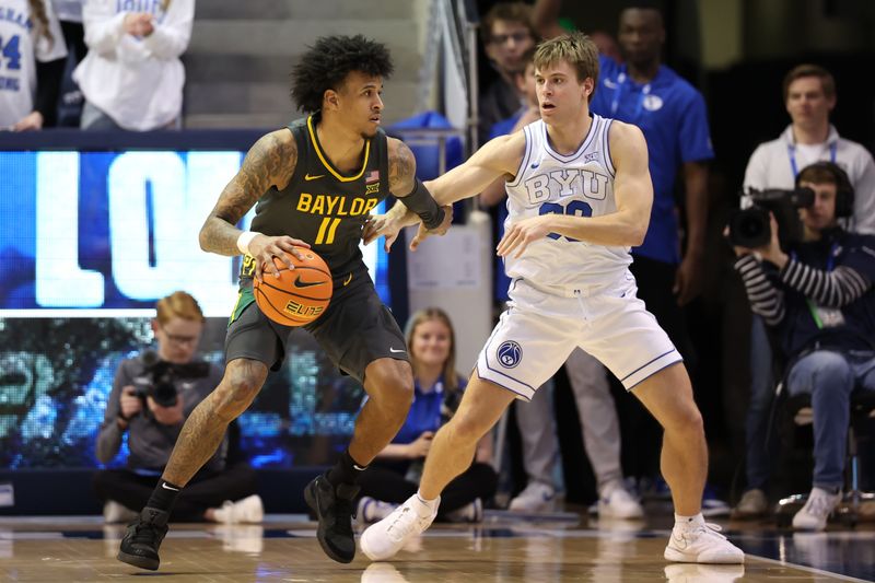 Feb 20, 2024; Provo, Utah, USA; Baylor Bears forward Jalen Bridges (11) dribbles toward the basket against Brigham Young Cougars guard Dallin Hall (30) during the second half at Marriott Center. Mandatory Credit: Rob Gray-USA TODAY Sports