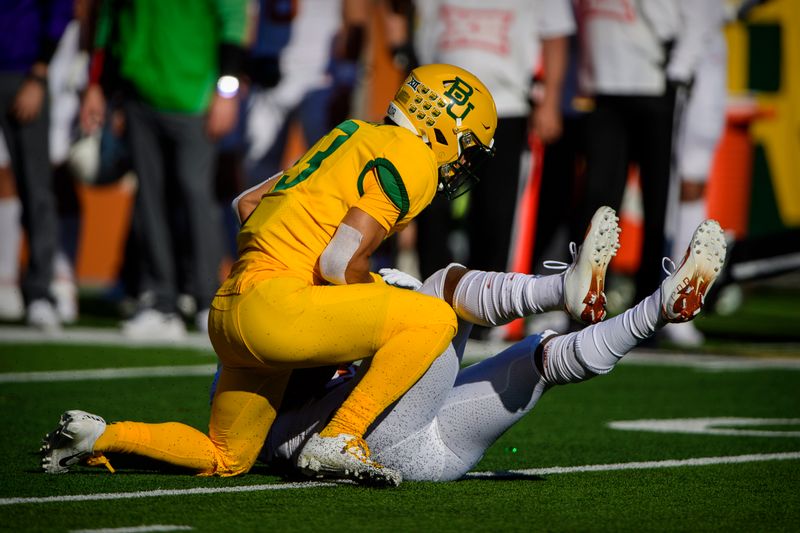 Nov 23, 2019; Waco, TX, USA; Baylor Bears cornerback Raleigh Texada (13) tackles Texas Longhorns running back Keaontay Ingram (26) during the first quarter at McLane Stadium. Mandatory Credit: Jerome Miron-USA TODAY Sports