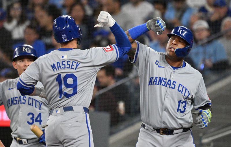 Apr 30, 2024; Toronto, Ontario, CAN;   Kansas City Royals second baseman Michael Massey (19) is greeted at home plate by first baseman Salvador Perez (13) after hitting a two-run home run against the Toronto Blue Jays in the second inning at Rogers Centre. Mandatory Credit: Dan Hamilton-USA TODAY Sports