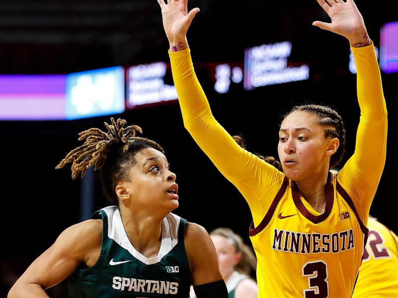 Jan 20, 2024; Minneapolis, Minnesota, USA; Michigan State Spartans guard DeeDee Hagemann (0) drives toward the basket as Minnesota Golden Gophers guard Amaya Battle (3) defends during the second half at Williams Arena. Mandatory Credit: Matt Krohn-USA TODAY Sports