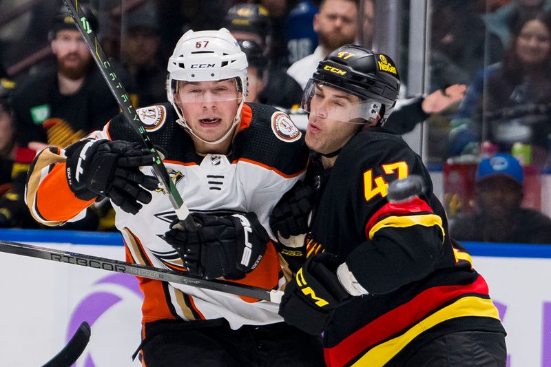 Nov 28, 2023; Vancouver, British Columbia, CAN; Vancouver Canucks defenseman Noah Juulsen (47) checks Anaheim Ducks defenseman Tristan Luneau (67) in the third period at Rogers Arena. Vancouver won 3-1. Mandatory Credit: Bob Frid-USA TODAY Sports