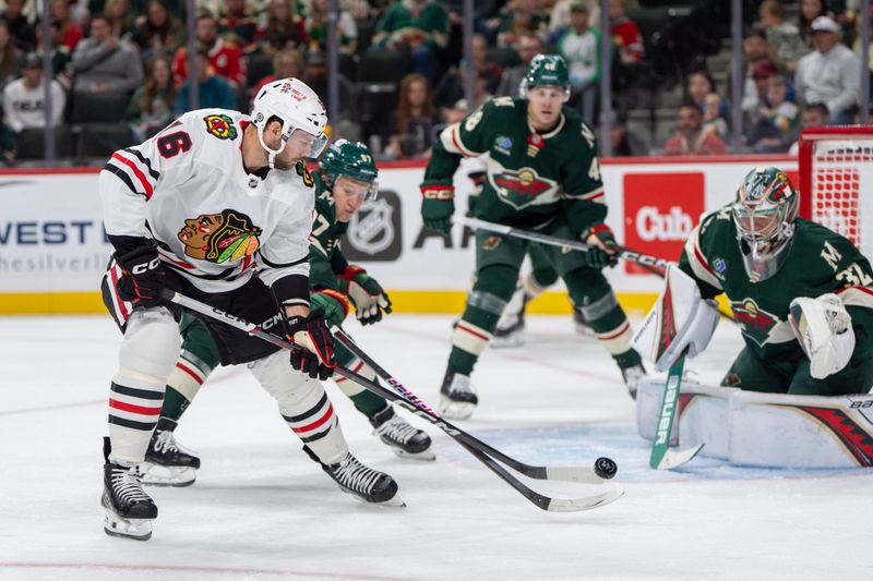 Oct 1, 2024; Saint Paul, Minnesota, USA; Chicago Blackhawks center Jason Dickinson (16) shoots on Minnesota Wild goaltender Filip Gustavsson (32) with left wing Kirill Kaprizov (97) on defense in the first period at Xcel Energy Center. Mandatory Credit: Matt Blewett-Imagn Images