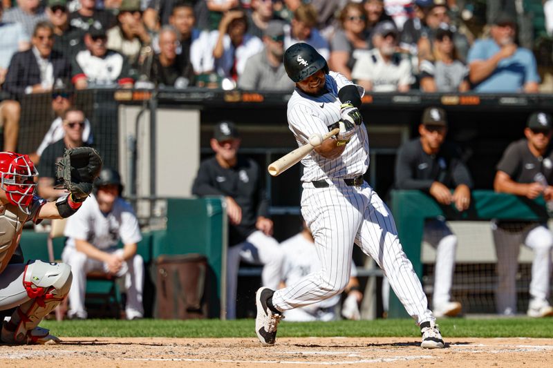 Sep 26, 2024; Chicago, Illinois, USA; Chicago White Sox third base Lenyn Sosa (50) hits a two-run double against the Los Angeles Angels during the fifth inning at Guaranteed Rate Field. Mandatory Credit: Kamil Krzaczynski-Imagn Images