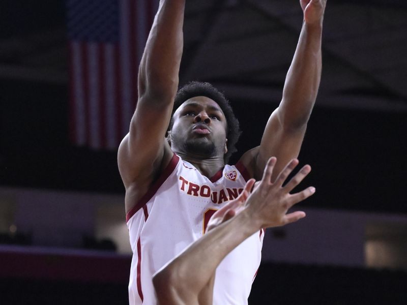 Dec 10, 2023; Los Angeles, California, USA; USC Trojans guard Bronny James (6) grabs a rebound in the first half against the Long Beach State 49ers at Galen Center. It was James   s first game since suffering a near fatal heart attack four months ago. Mandatory Credit: Robert Hanashiro-USA TODAY Sports