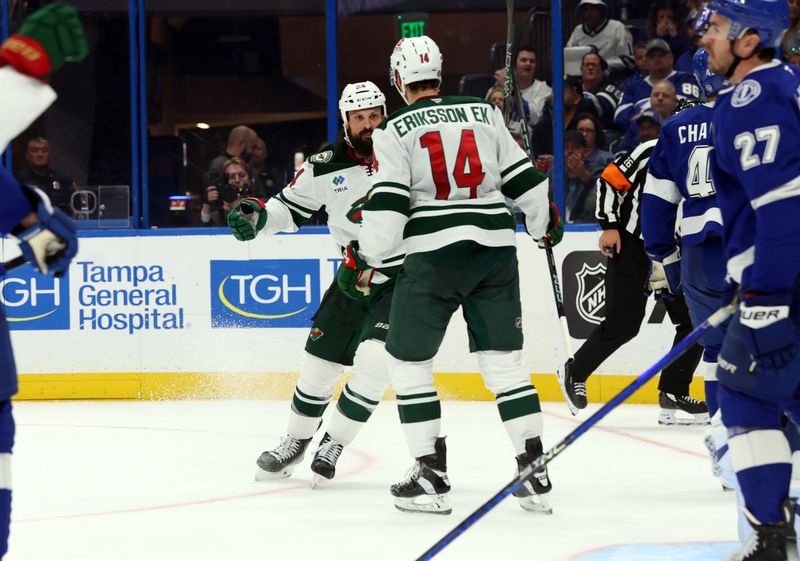 Oct 24, 2024; Tampa, Florida, USA; Minnesota Wild center Joel Eriksson Ek (14) is congratulated by Minnesota Wild defenseman Zach Bogosian (24) after he scored a goal against the Tampa Bay Lightning  during the second period at Amalie Arena. Mandatory Credit: Kim Klement Neitzel-Imagn Images