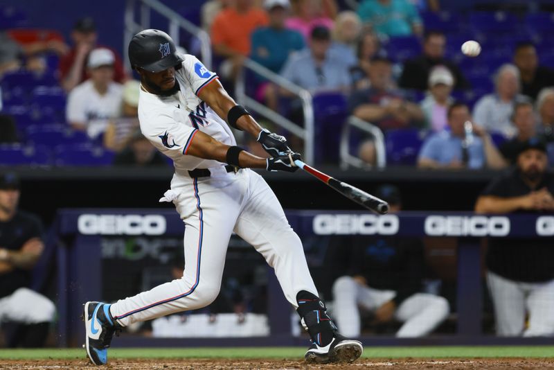 Apr 17, 2024; Miami, Florida, USA; Miami Marlins designated hitter Bryan De La Cruz (14) hits a home run against the San Francisco Giants during the sixth inning at loanDepot Park. Mandatory Credit: Sam Navarro-USA TODAY Sports