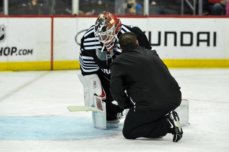 Apr 7, 2024; Newark, New Jersey, USA; New Jersey Devils goaltender Kaapo Kahkonen (31) receives medical attention after an injury during the first period against the Nashville Predators at Prudential Center. Mandatory Credit: John Jones-USA TODAY Sports