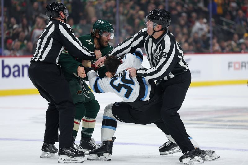 Mar 10, 2026; Saint Paul, Minnesota, USA; Minnesota Wild right wing Ryan Hartman (38) and Utah Mammoth defenseman MacKenzie Weegar (52) fight during the first period at Grand Casino Arena. Mandatory Credit: Matt Krohn-Imagn Images