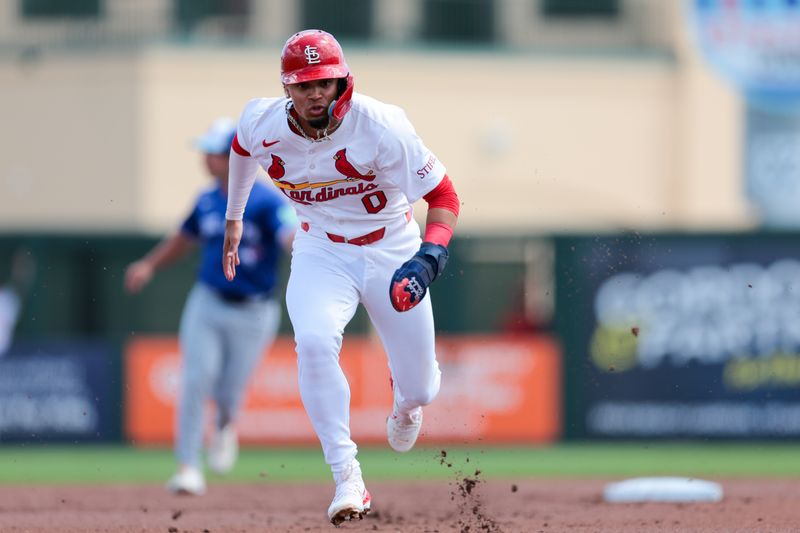 Mar 15, 2025; Jupiter, Florida, USA; St. Louis Cardinals shortstop Masyn Winn (0) runs toward third base against the Toronto Blue Jays during the first inning at Roger Dean Chevrolet Stadium. Mandatory Credit: Sam Navarro-Imagn Images