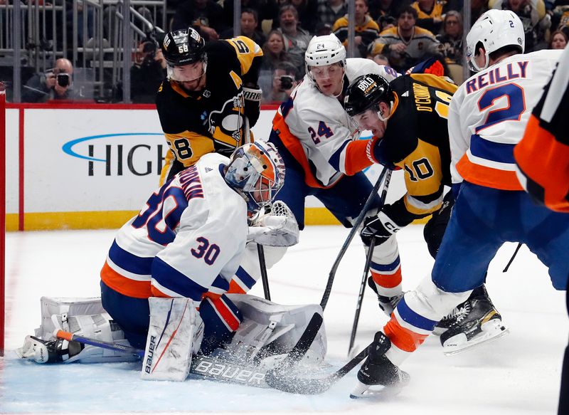 Feb 20, 2024; Pittsburgh, Pennsylvania, USA; New York Islanders goaltender Ilya Sorokin (30) defends the net against Pittsburgh Penguins left wing Drew O'Connor (10) during the third period at PPG Paints Arena. New York won 5-4 in overtime.Mandatory Credit: Charles LeClaire-USA TODAY Sports