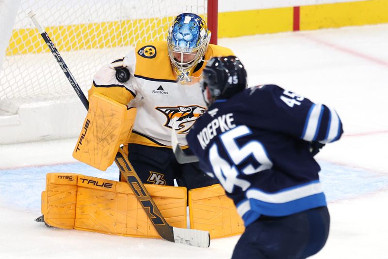 Oct 18, 2025; Winnipeg, Manitoba, CAN; Nashville Predators goaltender Juuse Saros (74) stops a shot by Winnipeg Jets left wing Cole Koepke (45) in the the third period at Canada Life Centre. Mandatory Credit: James Carey Lauder-Imagn Images