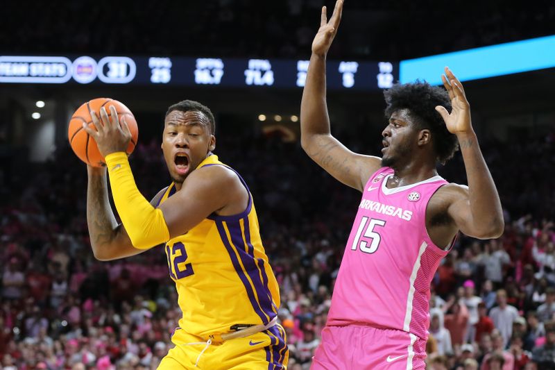 Jan 24, 2023; Fayetteville, Arkansas, USA; LSU Tigers forward KJ Williams (12) drives against Arkansas Razorbacks forward Makhi Mitchell (15) during the second half at Bud Walton Arena. Arkansas won 60-40. Mandatory Credit: Nelson Chenault-USA TODAY Sports