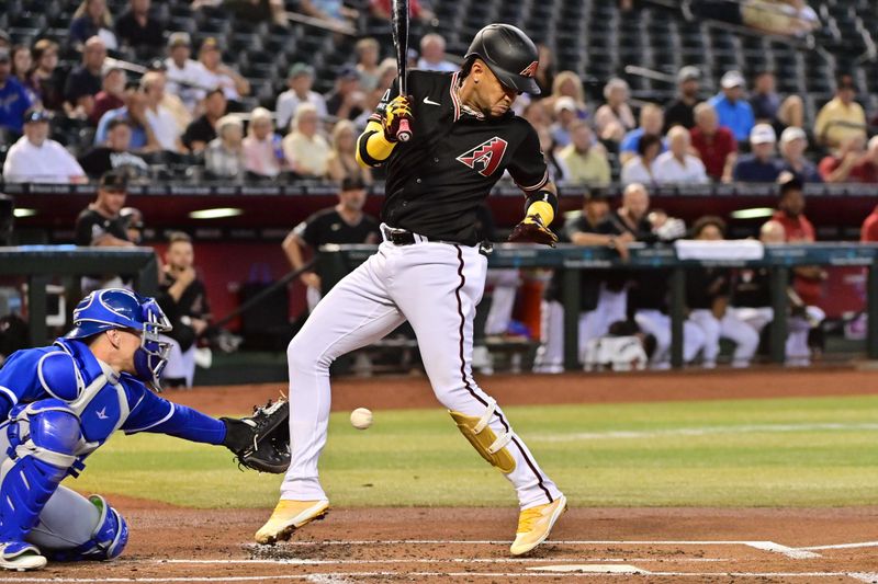 Apr 26, 2023; Phoenix, Arizona, USA; Arizona Diamondbacks second baseman Ketel Marte (4) is hit by a pitch in the first inning against the Kansas City Royals at Chase Field. Mandatory Credit: Matt Kartozian-USA TODAY Sports