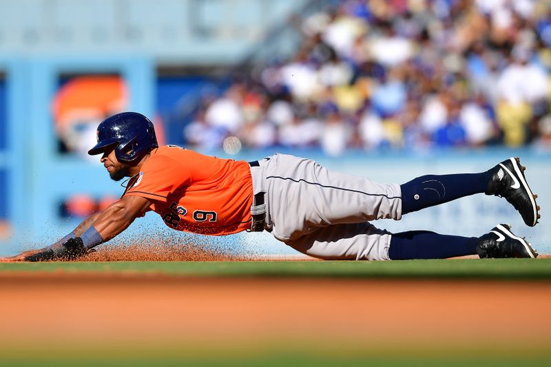 Jun 24, 2023; Los Angeles, California, USA; Houston Astros left fielder Corey Julks (9) reaches second after designated hitter Bligh Madris (26) is walked during the fifth inning at Dodger Stadium. Mandatory Credit: Gary A. Vasquez-USA TODAY Sports