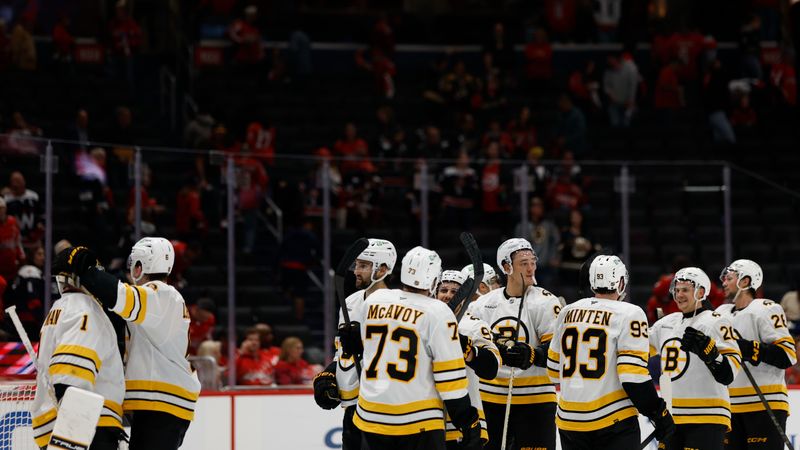 Oct 8, 2025; Washington, District of Columbia, USA; Boston Bruins goaltender Jeremy Swayman (1) celebrates with teammates after their game against the Washington Capitals at Capital One Arena. Mandatory Credit: Geoff Burke-Imagn Images