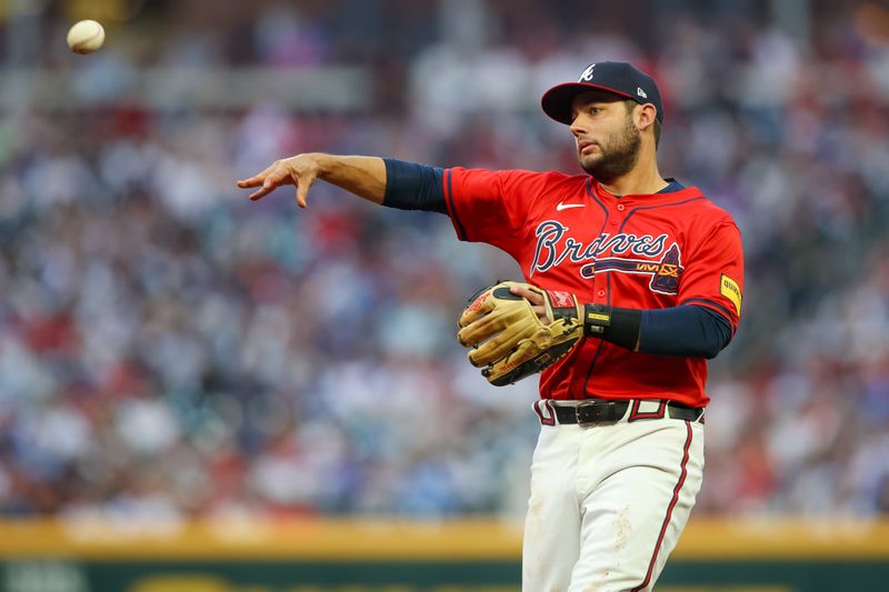 Apr 19, 2024; Atlanta, Georgia, USA; Atlanta Braves shortstop David Fletcher (22) throws a runner out at first against the Texas Rangers in the first inning at Truist Park. Mandatory Credit: Brett Davis-USA TODAY Sports