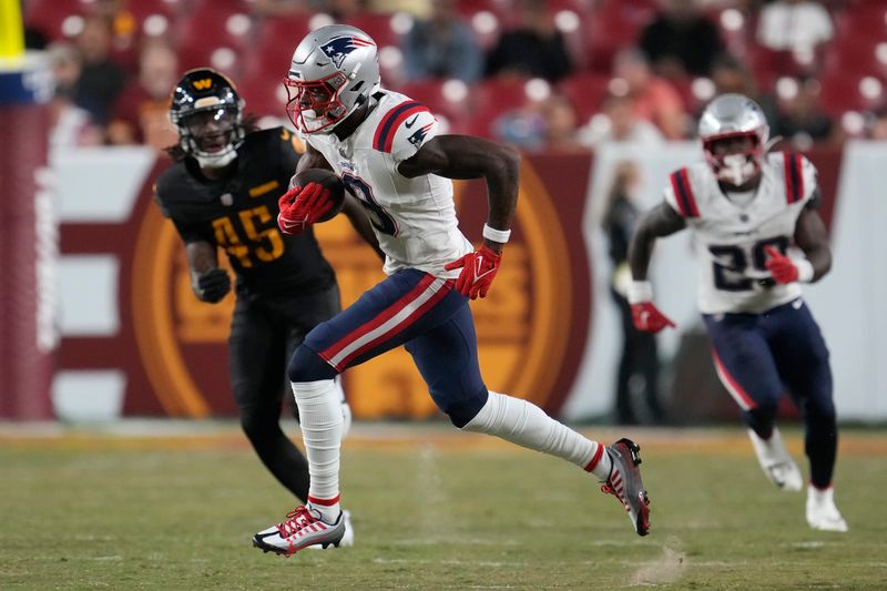 New England Patriots wide receiver Matt Landers, middle, runs in front of Washington Commanders safety Dominique Hampton (45) during the second half of a preseason NFL football game, Sunday, Aug. 25, 2024, in Landover, Md. (AP Photo/George Walker IV)