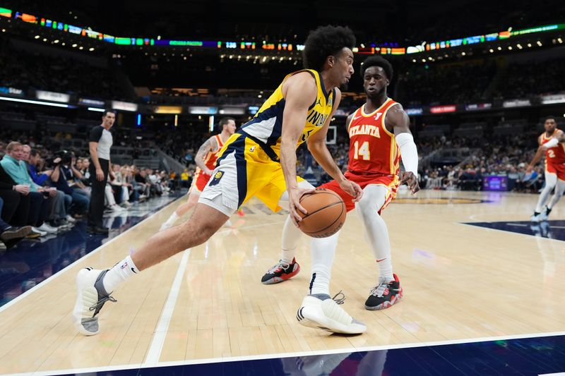 INDIANAPOLIS, INDIANA - JANUARY 05: Jordan Nwora #13 of the Indiana Pacers dribbles the ball while being guarded by AJ Griffin #14 of the Atlanta Hawks in the fourth quarter at Gainbridge Fieldhouse on January 05, 2024 in Indianapolis, Indiana. NOTE TO USER: User expressly acknowledges and agrees that, by downloading and or using this photograph, User is consenting to the terms and conditions of the Getty Images License Agreement. (Photo by Dylan Buell/Getty Images)