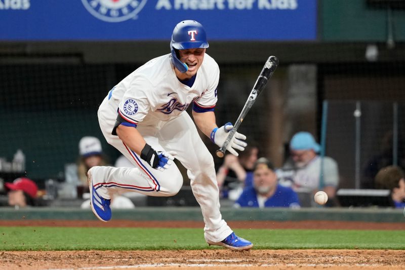 Apr 24, 2024; Arlington, Texas, USA; Texas Rangers shortstop Corey Seager (5) reacts after getting hit by a pitch thrown by Seattle Mariners pitcher Austin Voth (not shown) during the seventh inning at Globe Life Field. Mandatory Credit: Jim Cowsert-USA TODAY Sports