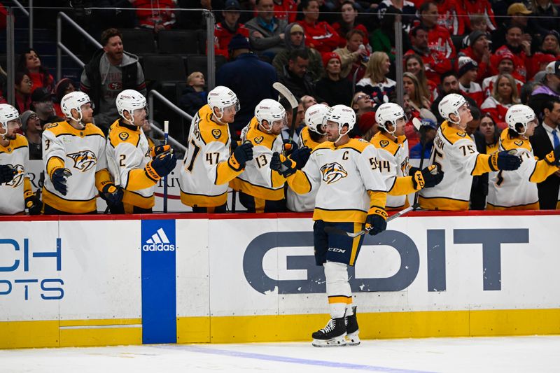 Dec 30, 2023; Washington, District of Columbia, USA; Nashville Predators defenseman Roman Josi (59) is congratulated by teammates after scoring a goal against the Washington Capitals during the first period at Capital One Arena. Mandatory Credit: Brad Mills-USA TODAY Sports