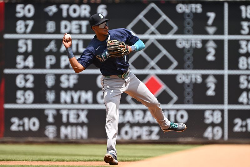 May 26, 2024; Washington, District of Columbia, USA; Seattle Mariners second baseman Jorge Polanco (7) attempts a throw to first base against the Washington Nationals during the second inning at Nationals Park. Mandatory Credit: Rafael Suanes-USA TODAY Sports