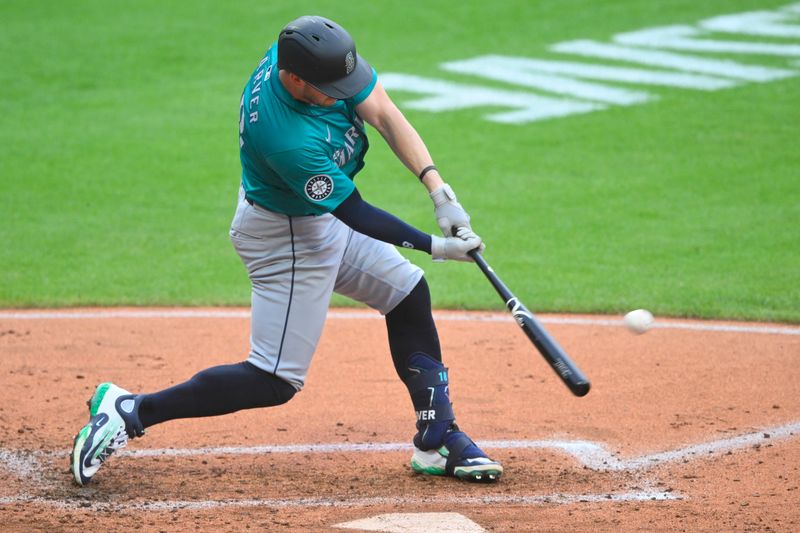 Jun 18, 2024; Cleveland, Ohio, USA; Seattle Mariners designated hitter Mitch Garver (18) hits an RBI double in the third inning against the Cleveland Guardians at Progressive Field. Mandatory Credit: David Richard-USA TODAY Sports