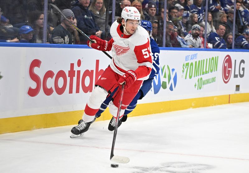 Jan 14, 2024; Toronto, Ontario, CAN; Detroit Red Wings defenseman Moritz Seider (53) skates the puck away from Toronto Maple Leafs forward Tyler Bertuzzi (59) in the first  period at Scotiabank Arena. Mandatory Credit: Dan Hamilton-USA TODAY Sports