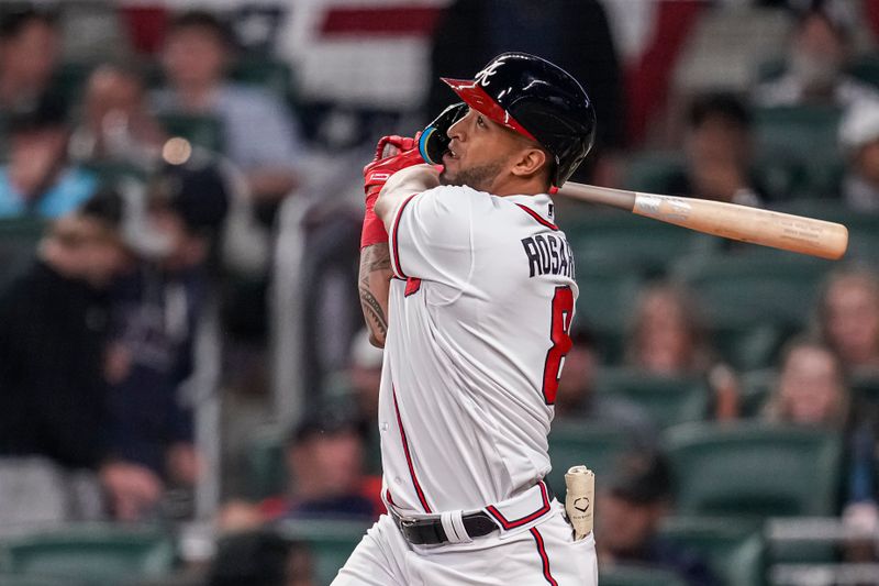 Apr 12, 2023; Cumberland, Georgia, USA; Atlanta Braves left fielder Eddie Rosario (8) watches the ball after hitting a home run against the Cincinnati Reds during the eighth inning at Truist Park. Mandatory Credit: Dale Zanine-USA TODAY Sports