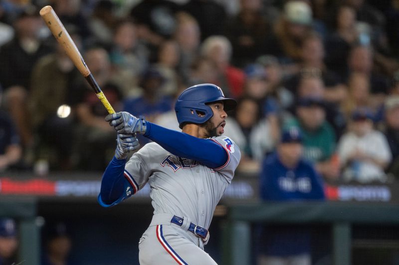 Sep 30, 2023; Seattle, Washington, USA; Texas Rangers centerfielder Leody Taveras (3) hits a RBI-single during the third inning against the Seattle Mariners at T-Mobile Park. Mandatory Credit: Stephen Brashear-USA TODAY Sports