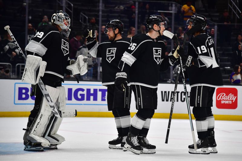 Mar 16, 2023; Los Angeles, California, USA; Los Angeles Kings goaltender Pheonix Copley (29) right wing Viktor Arvidsson (33) defenseman Sean Walker (26) and left wing Alex Iafallo (19) celebrate the victory against the Columbus Blue Jackets at Crypto.com Arena. Mandatory Credit: Gary A. Vasquez-USA TODAY Sports