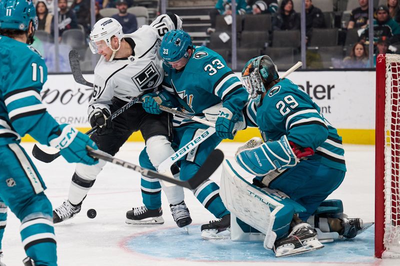 Apr 4, 2024; San Jose, California, USA; Los Angeles Kings center Trevor Lewis (61) vies for position in the goal crease against San Jose Sharks defenseman Calen Addison (33) and goaltender Mackenzie Blackwood (29) during the third period at SAP Center at San Jose. Mandatory Credit: Robert Edwards-USA TODAY Sports