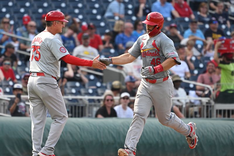 Jul 8, 2024; Washington, District of Columbia, USA; St. Louis Cardinals first baseman Paul Goldschmidt (46) celebrates hitting a home run with third base coach Ron Pop Warner (75) against the Washington Nationals during the fourth inning at Nationals Park. Mandatory Credit: Rafael Suanes-USA TODAY Sports