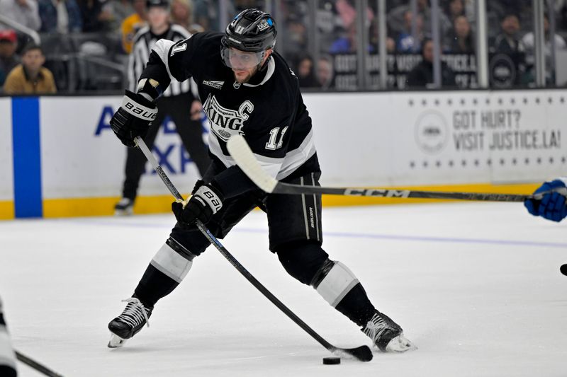 Apr 12, 2025; Los Angeles, California, USA; Los Angeles Kings center Anze Kopitar (11) takes a shot on goal in the second period against the Colorado Avalanche at Crypto.com Arena. Mandatory Credit: Jayne Kamin-Oncea-Imagn Images