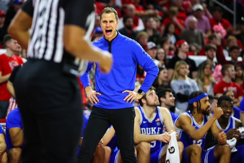 Jan 4, 2023; Raleigh, North Carolina, USA;  Duke Blue Devils head coach Jon Scheyer shouts at the referee during the second half against North Carolina State Wolfpack at PNC Arena. Mandatory Credit: Jaylynn Nash-USA TODAY Sports