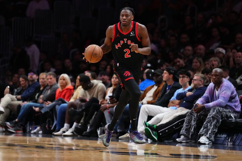 MIAMI, FLORIDA - DECEMBER 12: Jonathan Mogbo #2 of the Toronto Raptors dribbles the ball up the court against the Miami Heat during the fourth quarter at Kaseya Center on December 12, 2024 in Miami, Florida. NOTE TO USER: User expressly acknowledges and agrees that, by downloading and or using this Photograph, user is consenting to the terms and conditions of the Getty Images License Agreement. (Photo by Rich Storry/Getty Images)