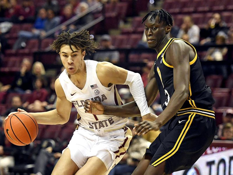 Feb 11, 2023; Tallahassee, Florida, USA; Florida State Seminoles guard Jalen Warley (1) maneuvers around Pittsburgh Panthers center Federiko Federiko (33) during the first half at Donald L. Tucker Center. Mandatory Credit: Melina Myers-USA TODAY Sports