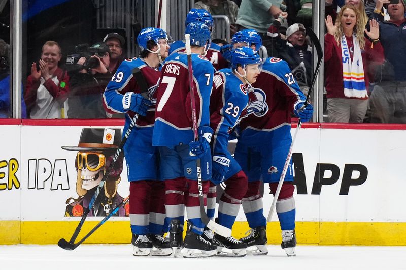 Mar 24, 2024; Denver, Colorado, USA; Colorado Avalanche center Nathan MacKinnon (29) celebrates his third period goal with right wing Mikko Rantanen (96) and defenseman Devon Toews (7) and left wing Jonathan Drouin (27) and defenseman Samuel Girard (49) against the Pittsburgh Penguins at Ball Arena. Mandatory Credit: Ron Chenoy-USA TODAY Sports