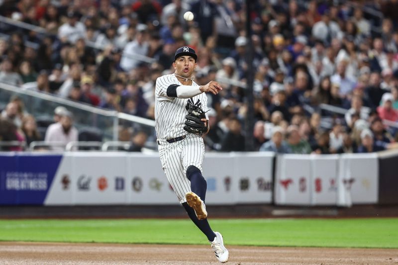 Aug 21, 2024; Bronx, New York, USA;  New York Yankees third baseman Oswald Peraza (91) makes a running throw to first base in the seventh inning against the Cleveland Guardians at Yankee Stadium. Mandatory Credit: Wendell Cruz-USA TODAY Sports