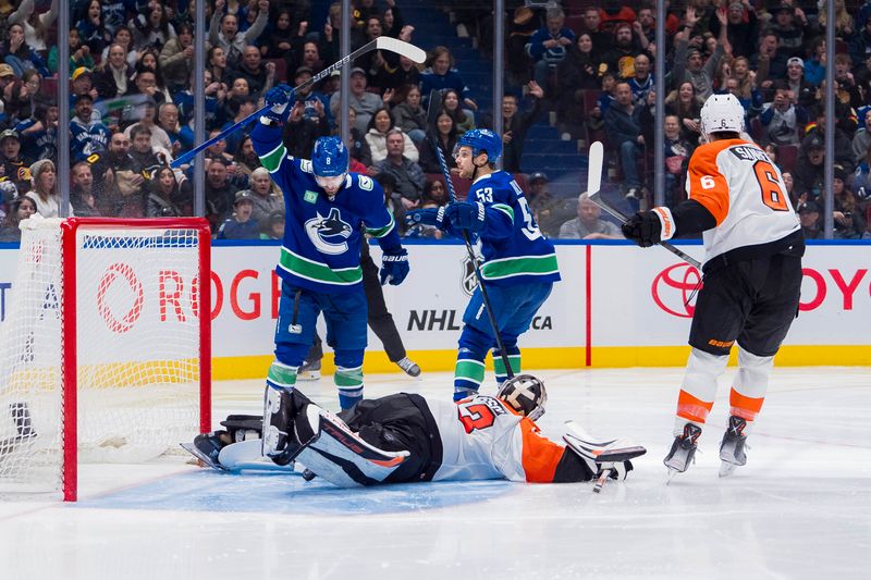 Dec 28, 2023; Vancouver, British Columbia, CAN; Vancouver Canucks forward Conor Garland (8) and forward Teddy Blueger (53) celebrate Blueger   s goal scored on Philadelphia Flyers goalie Samuel Ersson (33) as defenseman Travis Sanheim (6) looks on in the third period at Rogers Arena. Flyers won 4-1. Mandatory Credit: Bob Frid-USA TODAY Sports