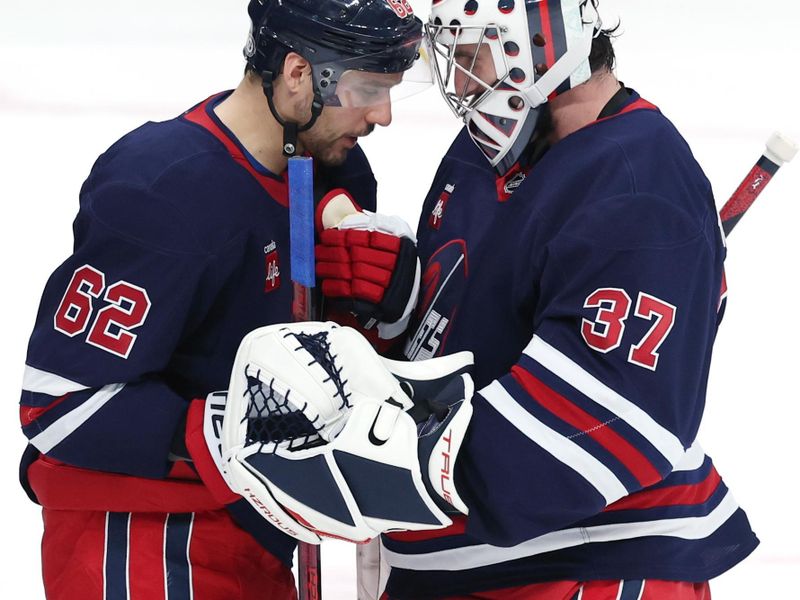 Jan 16, 2025; Winnipeg, Manitoba, CAN;  Winnipeg Jets goaltender Connor Hellebuyck (37)   and Winnipeg Jets right wing Nino Niederreiter (62) celebrate their victory over the Seattle Kraken at Canada Life Centre. Mandatory Credit: James Carey Lauder-Imagn Images