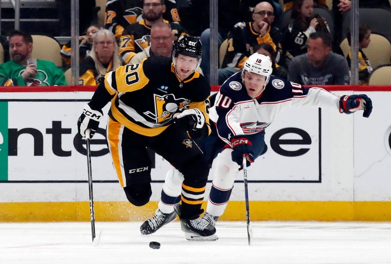 Mar 5, 2024; Pittsburgh, Pennsylvania, USA; Pittsburgh Penguins center Lars Eller (20) skates with the puck ahead of Columbus Blue Jackets left wing Dmitri Voronkov (10) during the third period at PPG Paints Arena. The Penguins won 5-3. Mandatory Credit: Charles LeClaire-USA TODAY Sports