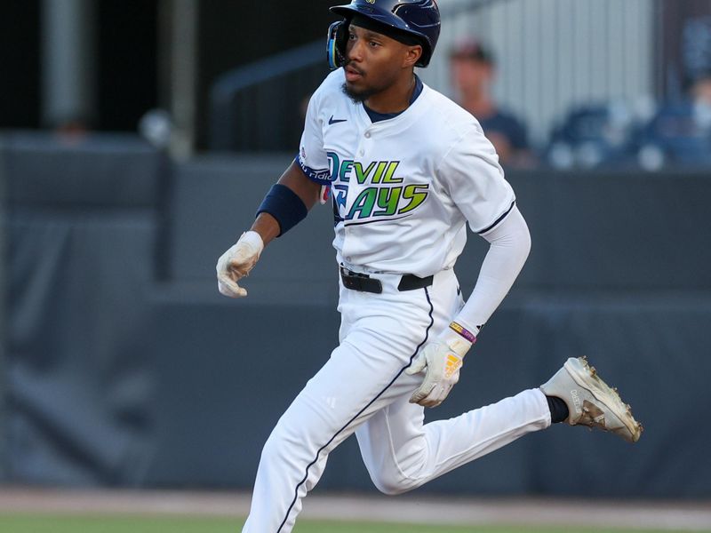 Apr 19, 2025; Tampa, Florida, USA; Tampa Bay Rays center fielder Chandler Simpson (14) doubles against the New York Yankees in the ninth inning at George M. Steinbrenner Field. Mandatory Credit: Nathan Ray Seebeck-Imagn Images