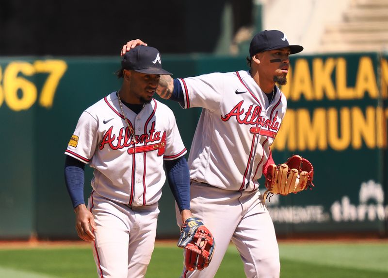 May 31, 2023; Oakland, California, USA; Atlanta Braves shortstop Orlando Arcia (11) puts his hand on the head of second baseman Ozzie Albies (1) after a win against the Oakland Athletics at Oakland-Alameda County Coliseum. Mandatory Credit: Kelley L Cox-USA TODAY Sports