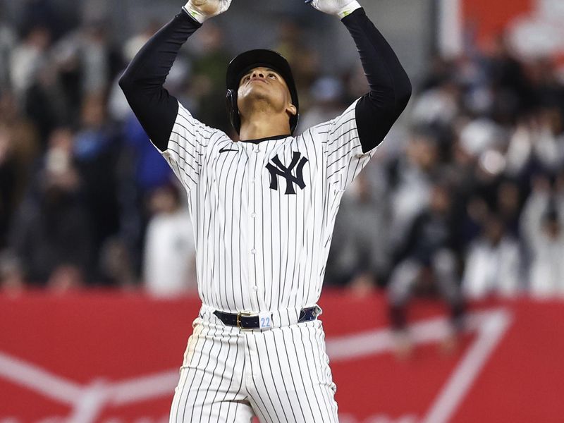 Apr 10, 2024; Bronx, New York, USA;  New York Yankees right fielder Juan Soto (22) gestures after hitting an RBI double in the eighth inning against the Miami Marlins at Yankee Stadium. Mandatory Credit: Wendell Cruz-USA TODAY Sports