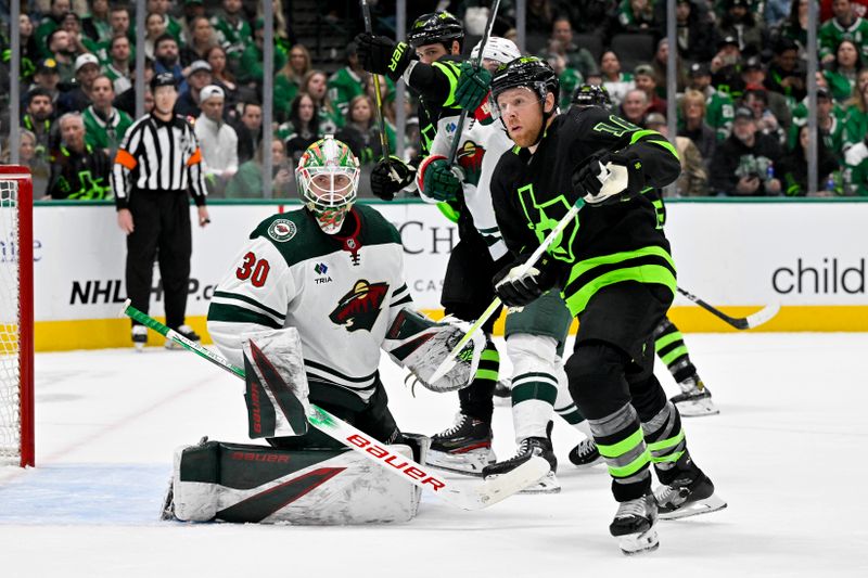 Jan 10, 2024; Dallas, Texas, USA; Minnesota Wild goaltender Jesper Wallstedt (30) and Dallas Stars center Joe Pavelski (16) look for the puck in the Wild zone during the second period at the American Airlines Center. Mandatory Credit: Jerome Miron-USA TODAY Sports