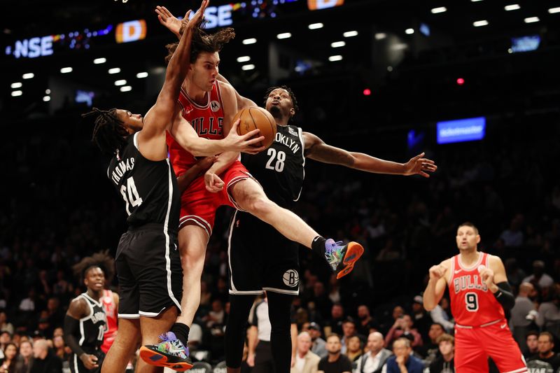 NEW YORK, NEW YORK - NOVEMBER 01: Josh Giddey #3 of the Chicago Bulls looks to pas as Cam Thomas #24 and Dorian Finney-Smith #28 of the Brooklyn Nets defend during the first half at Barclays Center on November 01, 2024 in the Brooklyn borough of New York City. NOTE TO USER: User expressly acknowledges and agrees that, by downloading and or using this photograph, User is consenting to the terms and conditions of the Getty Images License Agreement. (Photo by Sarah Stier/Getty Images)