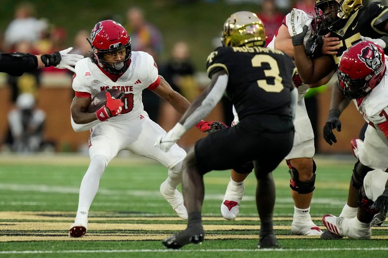 Nov 11, 2023; Winston-Salem, North Carolina, USA; North Carolina State Wolfpack wide receiver Kevin Concepcion (10) tries to elude Wake Forest Demon Deacons defensive back Malik Mustapha (3) during the second half at Allegacy Federal Credit Union Stadium. Mandatory Credit: Jim Dedmon-USA TODAY Sports